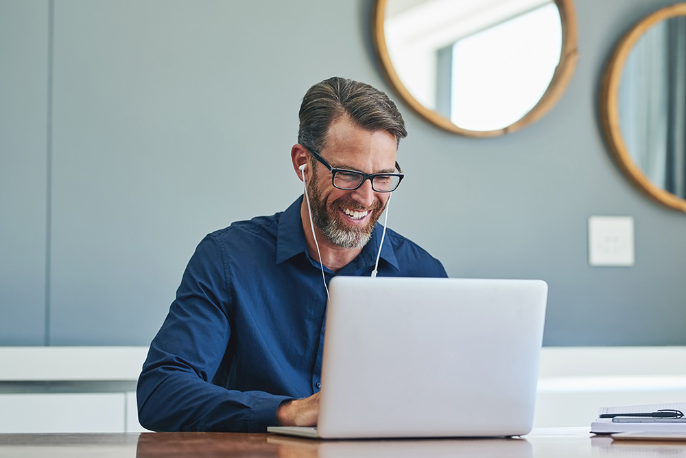 Man sitting in front of his laptop